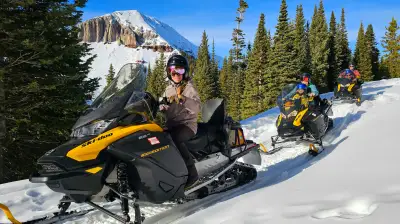 a group of people sitting in the snow